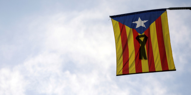 A Catalan separatist flag with a black ribbon hangs from a balcony in Barcelona, Spain, October 11, 2017. REUTERS/Susana Vera TPX IMAGES OF THE DAY