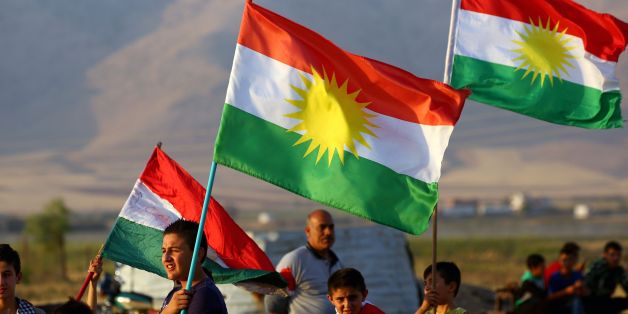 Syrian Kurds wave the Kurdish flag, in the northeastern Syrian city of Qamishli on September 27, 2017, during a gathering in support of the independence referendum in Iraq's autonomous northern Kurdish region.
Iraq's Kurds announced a massive 'yes' vote for independence following a referendum that has incensed Baghdad and sparked international concern. / AFP PHOTO / DELIL SOULEIMAN (Photo credit should read DELIL SOULEIMAN/AFP/Getty Images)