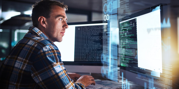 Shot of a young programmer working at his computer with an overlay of computer graphics