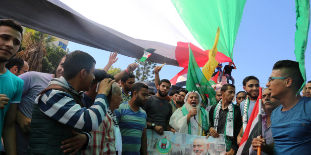A group of people gather in front of the the Unknown Soldier's monument to celebrate after Hamas and Fatah have reached an agreement after talks held since Tuesday in the Egyptian capital of Cairo, in Gaza City, Gaza on October 12, 201(Photo by Momen Faiz/NurPhoto via Getty Images)