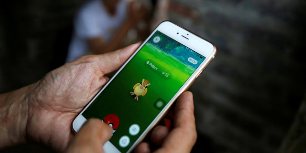 A man plays "Pokemon Go" by Hoan Kiem Lake in Hanoi, Vietnam, August 18, 2016. REUTERS/Kham