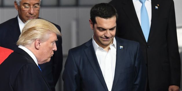 French President Emmanuel Macron (L) and German Chancellor Angela Merkel (2nd L) speaks as US President Donald Trump (C) arrives next to Greek Prime Minister Alexis Tsipras (R) for a family picture during the NATO (North Atlantic Treaty Organization) summit at the NATO headquarters, in Brussels, on May 25, 2017. / AFP PHOTO / Eric FEFERBERG (Photo credit should read ERIC FEFERBERG/AFP/Getty Images)