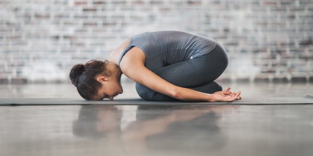 Young Woman Doing Yoga Meditation and Stretching Exercises. Stock photo.