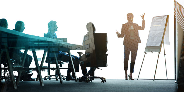 Multiple exposure shot of colleagues in a presentation superimposed over an urban background