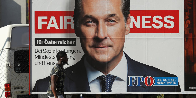 VIENNA, AUSTRIA - OCTOBER 14: A man of African origin walks past an election campaign billboard that shows Heinz-Christian Strache, lead candidate of the right-wing Austria Freedom Party (FPOe), on October 14, 2017 in Vienna, Austria. Austria faces parliamentary elections on October 15 and the FPOe, which is running on a 'fairness for Austrians' campaign with strong anti-immigrant, anti-refugee and anti-Islam tones, is currently in third place in polls and could well become a coalition partner
