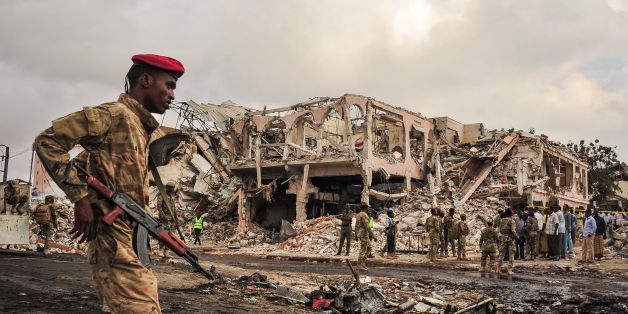 TOPSHOT - EDITORS NOTE: Graphic content / Somali soldiers patrol on the scene of the explosion of a truck bomb in the centre of Mogadishu, on October 15, 2017.A truck bomb exploded outside a hotel at a busy junction in Somalia's capital Mogadishu on October 14, 2017 causing widespread devastation that left at least 20 dead, with the toll likely to rise. / AFP PHOTO / Mohamed ABDIWAHAB (Photo credit should read MOHAMED ABDIWAHAB/AFP/Getty Images)