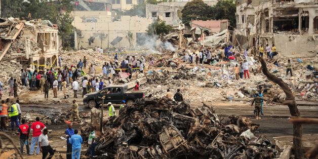 TOPSHOT - EDITORS NOTE: Graphic content / A picture taken on October 15, 2017 shows a general view of the scene of the explosion of a truck bomb in the centre of Mogadishu.A truck bomb exploded outside a hotel at a busy junction in Somalia's capital Mogadishu on October 14, 2017 causing widespread devastation that left at least 20 dead, with the toll likely to rise. / AFP PHOTO / Mohamed ABDIWAHAB (Photo credit should read MOHAMED ABDIWAHAB/AFP/Getty Images)