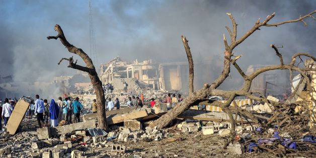 Men and Somalian soldiers arrive on the site to rescue victims of the explosion of a truck bomb in the centre of Mogadishu, on October 14, 2017.
A truck bomb exploded outside a hotel at a busy junction in Somalia's capital Mogadishu on October 14, 2017 causing widespread devastation that left at least 20 dead, with the toll likely to rise. / AFP PHOTO / Mohamed ABDIWAHAB (Photo credit should read MOHAMED ABDIWAHAB/AFP/Getty Images)