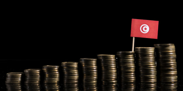 Tunisian flag with lot of coins isolated on black background