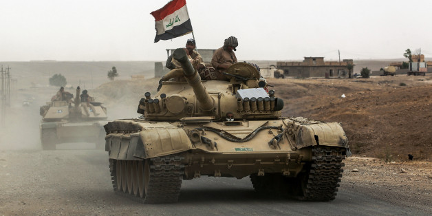 Iraqi soldiers ride atop the turret of a Russian-made T-72 tank, as Iraqi forces advance towards the city of al-Sharqat on September 20, 2017, where Iraqi forces backed by Hashed al-Shaabi (Popular Mobilisation) paramilitaries are preparing to retake the jihadist-held city of Hawijah in the province of Kirkuk, 300 kilometres (185 miles) northwest of Baghdad. / AFP PHOTO / AHMAD AL-RUBAYE (Photo credit should read AHMAD AL-RUBAYE/AFP/Getty Images)