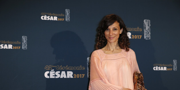 Director Houda Benyamina poses with her trophy during a photocall after receiving the Best First Film Award for her film "Divines" at the 42nd Cesar Awards ceremony in Paris, France, February 24, 2017. REUTERS/Gonzalo Fuentes