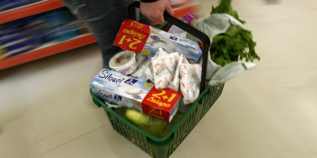 A woman carries her groceries in a basket as she shops in a supermarket on the first day of the implementation of tax increases in Athens March 15, 2010. Under pressure from markets and European Union partners, the government unveiled a new austerity package last week worth 4.8 billion euros ($6.51 billion). It included a rise in value added tax (VAT), cuts in civil service incomes and a pension freeze. REUTERS/Yiorgos Karahalis (GREECE - Tags: POLITICS BUSINESS SOCIETY)