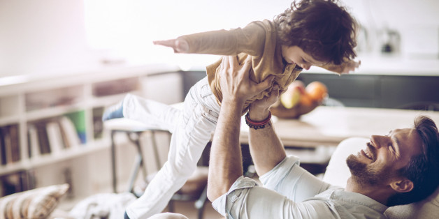 Close up of a father playing with his son.