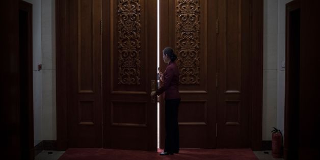 A hostess closes the door of a meeting room at the Great Hall of the People during the Communist Party's 19th Congress in Beijing on October 19, 2017.
The Chinese Communist Party opens its week-long, twice-a-decade congress on October 18 at the Great Hall of the People. / AFP PHOTO / FRED DUFOUR (Photo credit should read FRED DUFOUR/AFP/Getty Images)