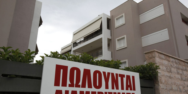 A sign advertises 'apartments for sale,' outside a new luxury housing development in the Glyka Nera suburb of Athens, Greece, on Sunday, Sept. 5, 2010. Greece still faces a 'substantial' default risk as insolvency prevents the nation from repaying its debt when its bailout program expires in three years. Photographer: Kostas Tsironis/Bloomberg via Getty Images