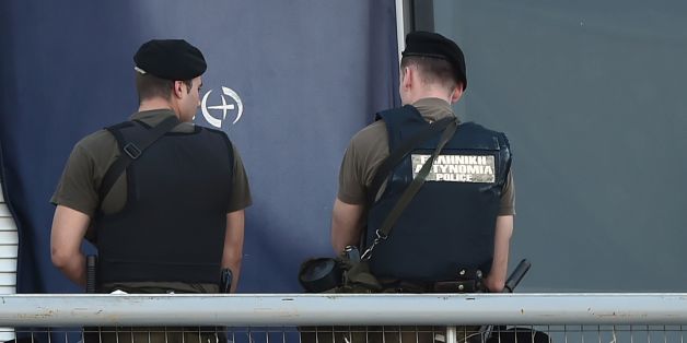A migrant holds a baby during a police operation to evacuate a disused terminal building of the former international airport, which is used as a shelter for mainly Afghan migrants on June 2, 2017, south of Athens.
Greek police early on June 2, 217 began evacuating the last remaining migrants and refugees from a makeshift camp at Hellinikon, a disused former airport and ex-Olympic facility south of Athens .The mainly Afghan refugees were living at the camp at Hellinikon -- which until 2001 was the Athens airport -- in crumbling flight lounges and abandoned sports facilities built for the 2004 Olympics. / AFP PHOTO / LOUISA GOULIAMAKI (Photo credit should read LOUISA GOULIAMAKI/AFP/Getty Images)