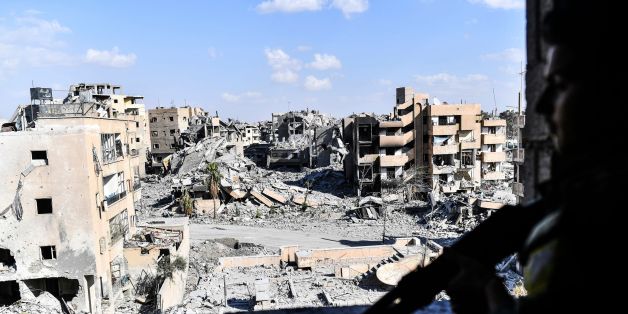 A member of the Syrian Democratic Forces (SDF) holds a position near the central hospital of Raqa on October 1, 2017. Syrian fighters backed by US special forces are battling to clear the last remaining Islamic State group jihadists holed up in their crumbling stronghold of Raqa. / AFP PHOTO / BULENT KILIC (Photo credit should read BULENT KILIC/AFP/Getty Images)
