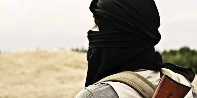 Muslim rebel with automatic rifle and machine-gun belt