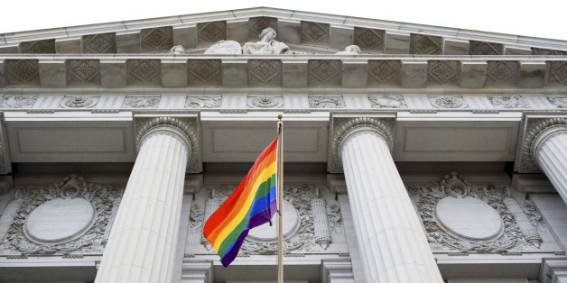 Lesbian, gay, bisexual, and transgender pride flag flying outside a government building