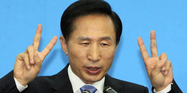 South Korea's Grand National Party (GNP) presidential candidate Lee Myung-Bak gestures his party's number (#2) during a press conference in Seoul, 18 December 2007.  The race's 12 candidates were making their final pitches to South Korean voters before the presidential election 19 December, with frontrunner Lee Myung-Bak facing a damaging fraud probe even if he wins the poll.         AFP PHOTO / LEE JONG-SEUNG (Photo credit should read LEE JONG-SEUNG/AFP/Getty Images)