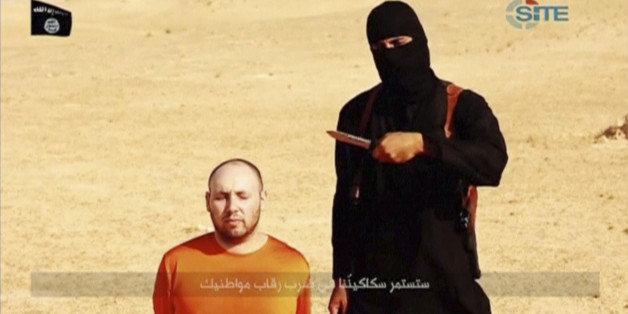 A masked, black-clad militant, who has been identified by the Washington Post newspaper as a Briton named Mohammed Emwazi, stands next to a man purported to be Steven Sotloff in this still image from a video obtained from SITE Intel Group website February 26, 2015. The "Jihadi John" killer who has featured in several Islamic State beheading videos is Emwazi, a Briton from a middle class family who grew up in London and graduated from college with a degree in computer programming, the Washington