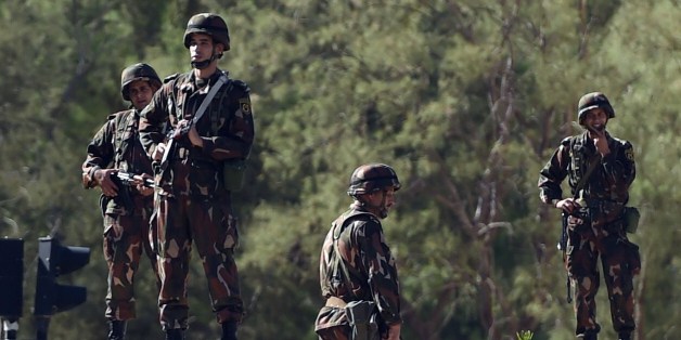 Members of the Algerian Republican Guard stand guard outside the presidential palace on October 16, 2014 in the capital Algiers, as police forces demonstrate over working conditions next to the building. AFP PHOTO/FAROUK BATICHE (Photo credit should read FAROUK BATICHE/AFP/Getty Images)