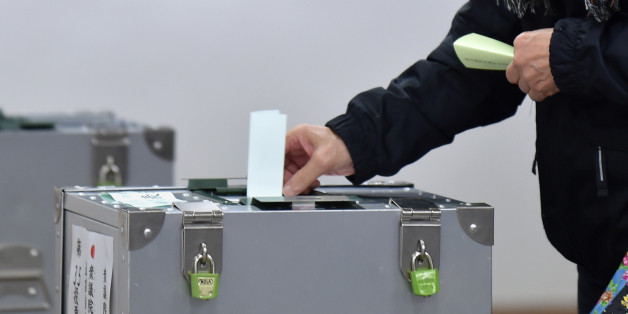 A woman casts her vote in Japan's general election at a polling station in Tokyo on October 22, 2017. Polls opened in Japan for a snap election, with Prime Minister Shinzo Abe's conservatives expected to cruise to a comfortable majority after a campaign dominated by North Korea and the economy. / AFP PHOTO / Kazuhiro NOGI (Photo credit should read KAZUHIRO NOGI/AFP/Getty Images)