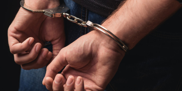 Close up of male hands in bracelets behind back