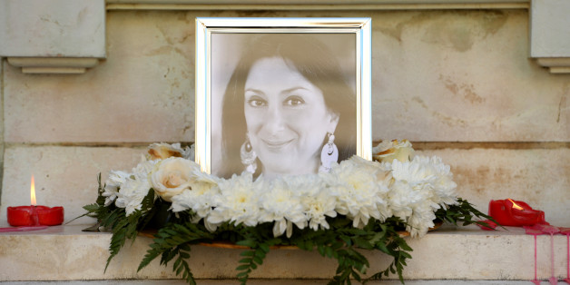 Flowers and tributes lay at the foot of the Great Siege monument in Valletta, Malta, on October 19, 2017 which has been turned into a temporary shrine for Maltese journalist and blogger Daphne Caruana Galizia (picture) who was killed by a car bomb outside her home in Bidnjia, Malta, on October 16, 2017. / AFP PHOTO / Matthew Mirabelli (Photo credit should read MATTHEW MIRABELLI/AFP/Getty Images)