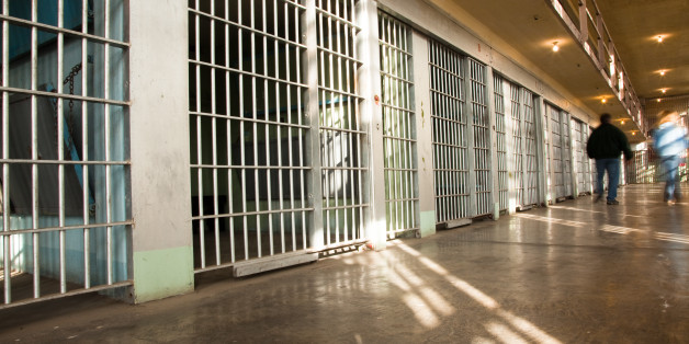 Inside The Old Idaho State Penitentiary - two people walking away from the camera with intentional motion blur.