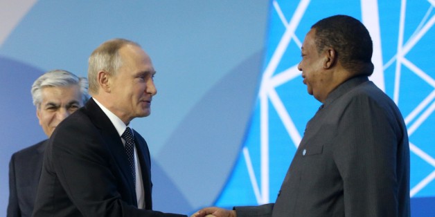 MOSCOW, RUSSIA - OCTOBER 04: (RUSSIA OUT) Russian President Vladimir Putin (L) greets OPEC Secretary General Mohamed Barkindo (R) during the plenary session of Russian Energy Week on October 4, 2017. in Moscow, Russia. (Photo by Mikhail Svetlov/Getty Images)