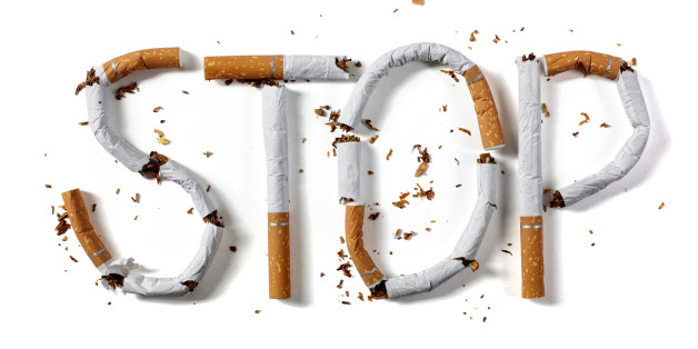 Stop smoking word written with broken cigarette concept for quitting smoking