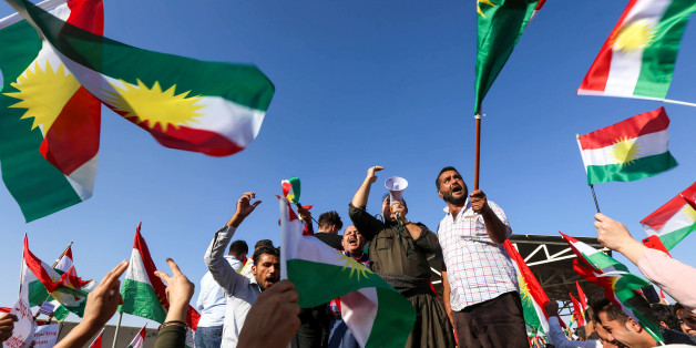 Iraqi Kurds wave flags of Iraqi Kurdistan and shout slogans during a demonstration outside the UN Office in Arbil, the capital of the autonomous region, on October 21, 2017, protesting against the escalating crisis with Baghdad. / AFP PHOTO / SAFIN HAMED (Photo credit should read SAFIN HAMED/AFP/Getty Images)