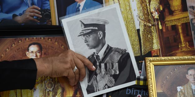 A woman holds an image of the late Thai King Bhumibol Adulyadej as mourners wait for his funeral to begin in Bangkok on October 25, 2017.The kingdom has been preparing for the cremation of the former king following his death at the age of 88 on October 13, 2016, triggering an outpouring of grief in a nation where the charismatic leader commanded a cult-like following. / AFP PHOTO / Lillian SUWANRUMPHA (Photo credit should read LILLIAN SUWANRUMPHA/AFP/Getty Images)