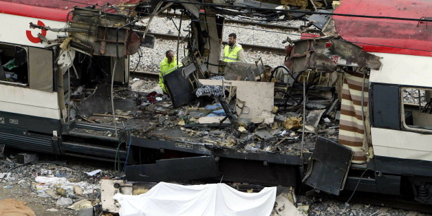 Police specialist inspect the wreckage of a public train near to Atocha train station in Madrid, March 12, 2004. At least 198 people were killed and over 1,400 injured in the bomb attacks in Madrid on March 11.