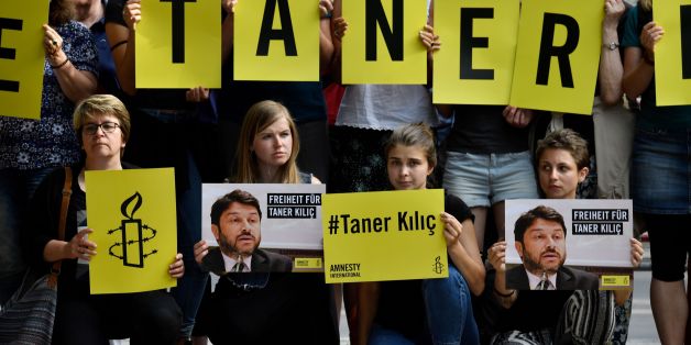Activists of Amnesty International stage a protest against the detention of the head of Amnesty International in Turkey, Taner Kilic, in front of the Turkish Embassy in Berlin on June 15, 2017.Taner Kilic was arrested in the Turkish province of Izmir along with 22 other lawyers on June 6, 2017 and has been charged with membership of a terrorist organisation and remanded in custody pending trial / AFP PHOTO / John MACDOUGALL (Photo credit should read JOHN MACDOUGALL/AFP/Getty Images)