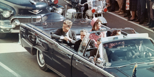 President and Mrs. John F. Kennedy smile at the crowds lining their motorcade route in Dallas, Texas, on November 22, 1963. Minutes later the President was assassinated as his car passed through Dealey Plaza.