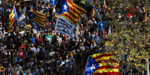 People holding Esteladas (Pro-independence Catalan flag) gather outside the Catalan parliament in Barcelona on October 27, 2017, during a plenary session to debate a motion on declaring independence from Spain.The Catalan parliament will vote on how to respond to the central government's planned takeover of Catalan political powers following an outlawed independence referendum. / AFP PHOTO / PAU BARRENA (Photo credit should read PAU BARRENA/AFP/Getty Images)