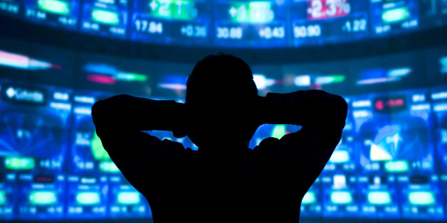 young man standing in front of the projection reflected stock market