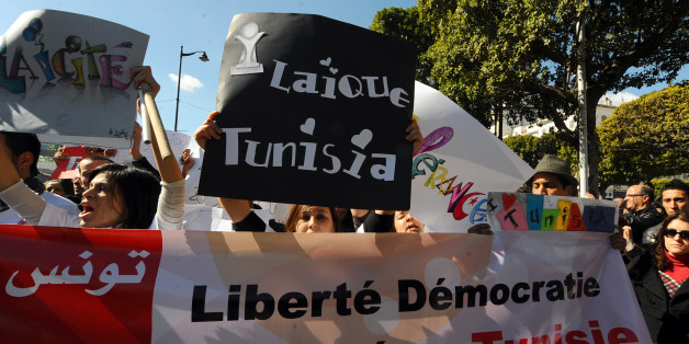 Demonstrators protest on Habib Bourguiba Avenue in Tunis on February 19, 2011, to demand a secular state following the murder of a Polish priest, verbal attacks on Jews and an attempt by Islamists to set fire to a brothel. The banner reads: 'Freedom, democraty, secularism in Tunisia'. AFP PHOTO / FETHI BELAID (Photo credit should read FETHI BELAID/AFP/Getty Images)
