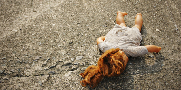 Abandoned Dirty Toy Doll on a Street