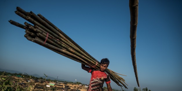 COXS BAZAR, BANGLADESH - OCTOBER 27: A Rohingya Muslim carries bamboo logs at Kutupalong Rohingya refugee camp in Coxs Bazar, Bangladesh on October 27, 2017. 15,000 Rohingya refugees have taken shelter at Kutupalong refugee camp after fleeing from Myanmar's violence. (Photo by Stringer/Anadolu Agency/Getty Images)