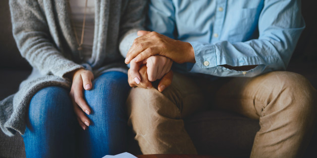 Closeup shot of a couple holding hands in comfort