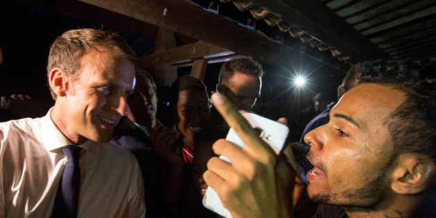 French President Emmanuel Macron speaks to a resident during a visit to the Cogneau Lamirande neighborhood in Matoury, French Guiana, October 27, 2017. Picture taken October 27, 2017. REUTERS/Ronan Lietar