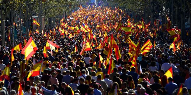 People wave Spanish and Catalan Senyera flags during a pro-unity demonstration in Barcelona on October 29, 2017.
Pro-unity protesters were to gather in Catalonia's capital Barcelona, two days after lawmakers voted to split the wealthy region from Spain, plunging the country into an unprecedented political crisis. / AFP PHOTO / PIERRE-PHILIPPE MARCOU (Photo credit should read PIERRE-PHILIPPE MARCOU/AFP/Getty Images)