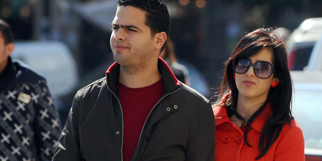 A Tunisian couple walks in Habib Bourguiba Avenue on February 28, 2012 in Tunis. The Association Tunisian Democratic Women (ATFD) is organizing a conference on strengthening and promotion of women's rights in Tunisia during the democratic transition and drafting of the Constitution, at the initiative of the Euro-Mediterranean Human Rights. The legal status of women in Tunisia is unique in the Arab world giving strict equality between men and women since since 1956. AFP PHOTO / FETHI BELAID (Pho