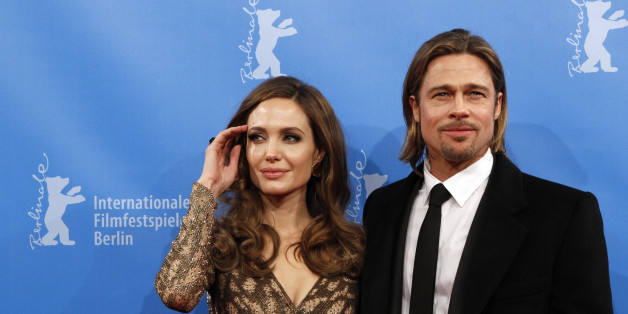 U.S. actress and director Angelina Jolie and her partner actor Brad Pitt arrive for the screening of the movie 'The Land Of Blood And Honey' at the 62nd Berlinale International Film Festival in Berlin February 11, 2012. REUTERS/Fabrizio Bensch (GERMANY - Tags: ENTERTAINMENT)