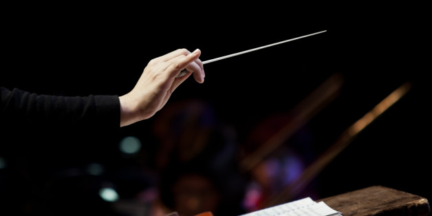 conductor's hand on a black background