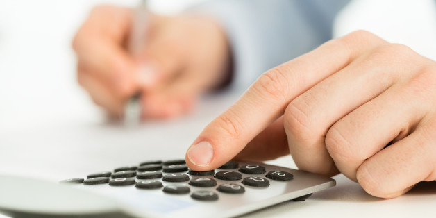 Close-up of a man's hand on a calculator.