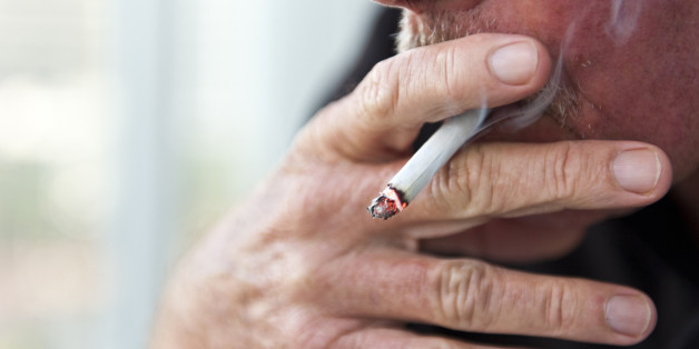 Caucasian old man smoking a cigarette